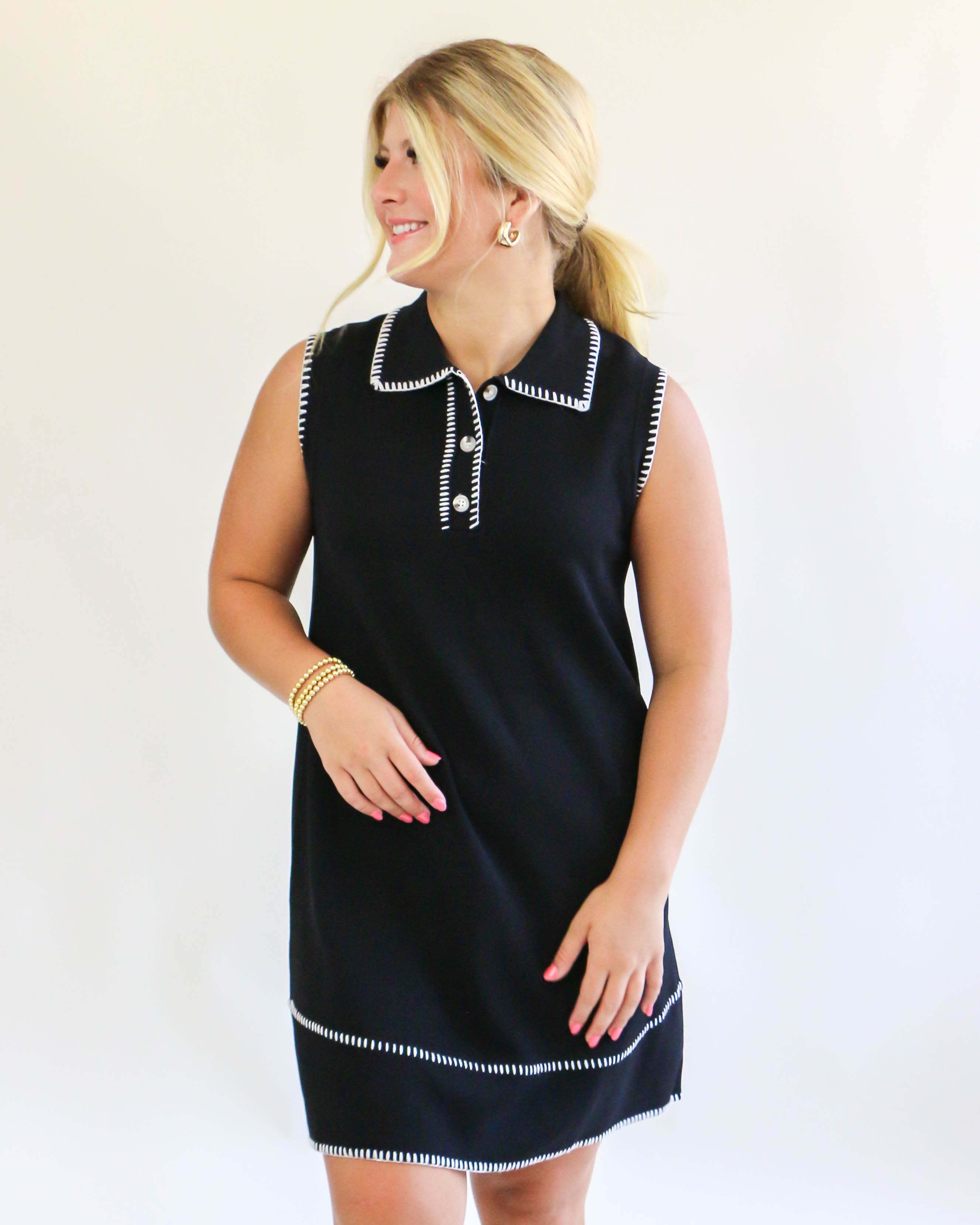 Collared sleeveless black dress with cream trim