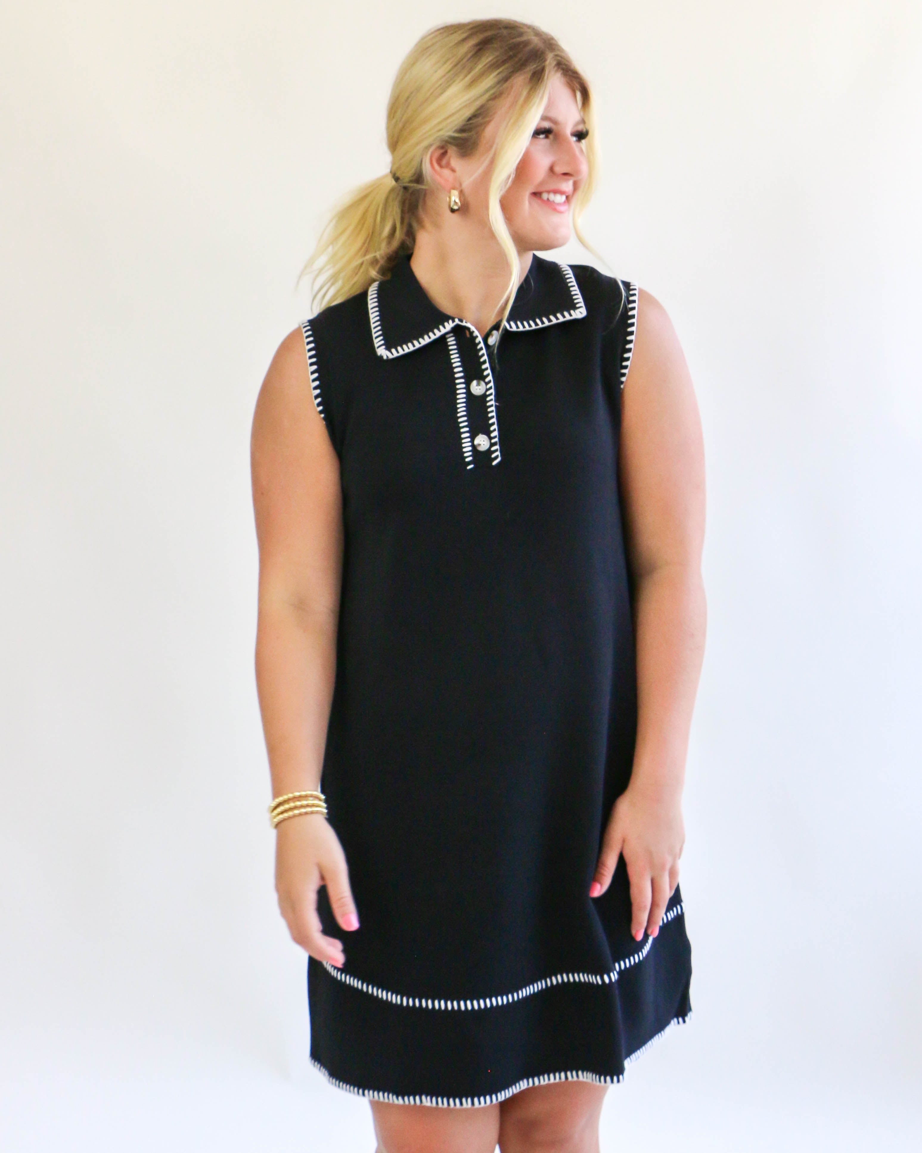 Collared sleeveless black dress with cream trim