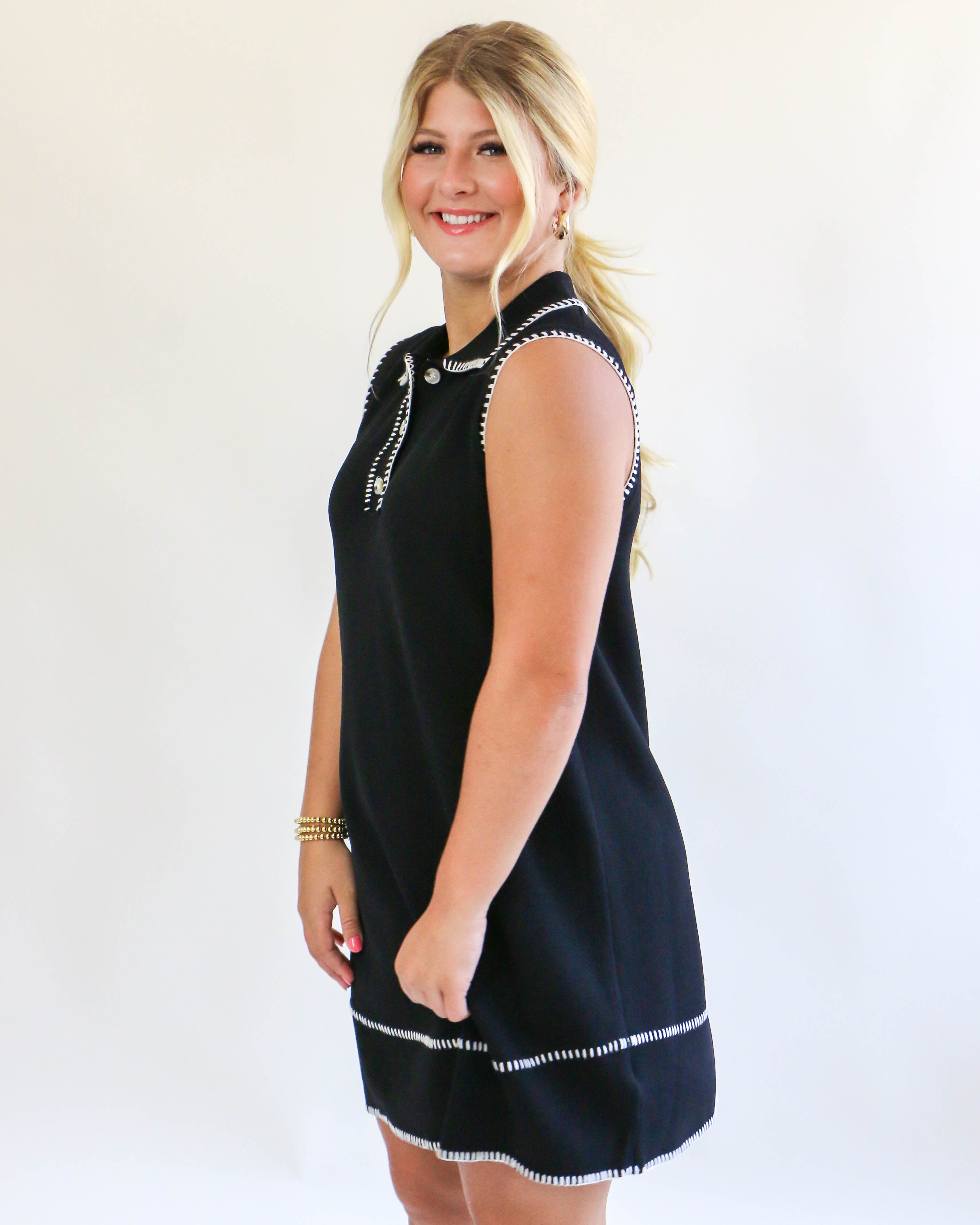 Collared sleeveless black dress with cream trim