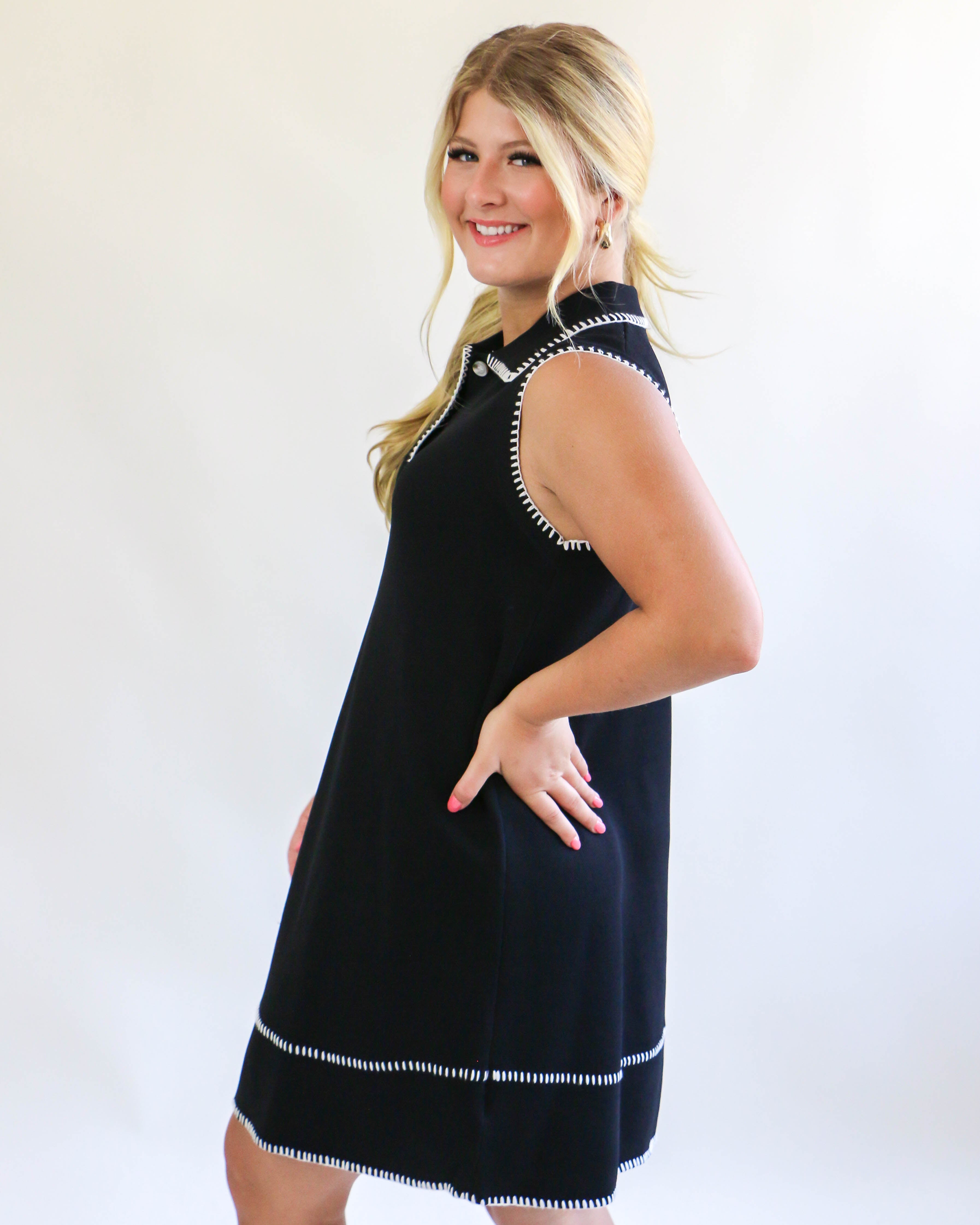 Collared sleeveless black dress with cream trim